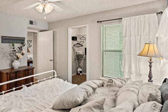 a bedroom with a bed and a lamp in it