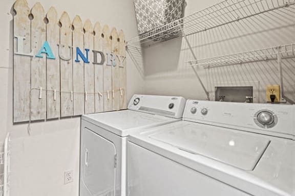 a laundry room with two washes and a dryer
