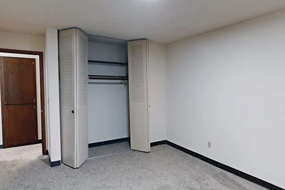A room with a large sliding door closet