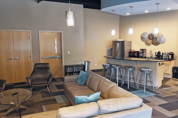 A modern living room with a bar area and a sofa.
