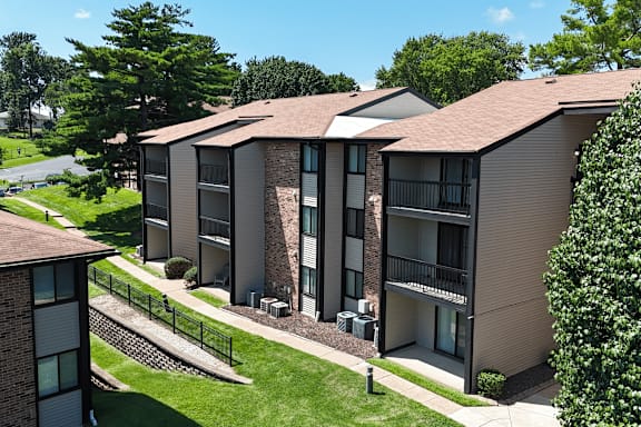Apartment complex with a green lawn in front.