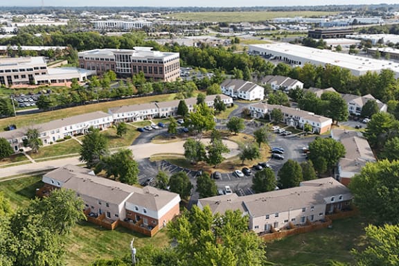 an aerial view of the campus with buildings and cars in the parking lot