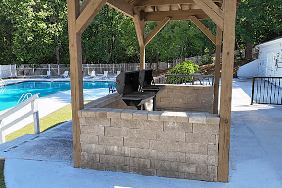 A wooden structure with a speaker on top of a brick wall.