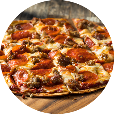 A pizza with pepperoni and sausage on a wooden table.