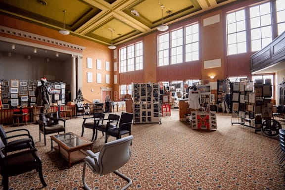 A large room with a lot of furniture and a patterned carpet.