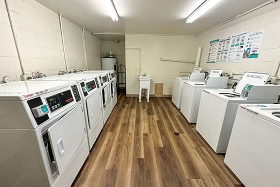 a room with a bunch of washing machines in it