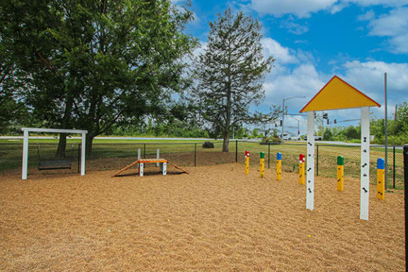 a playground with a picnic table and swings