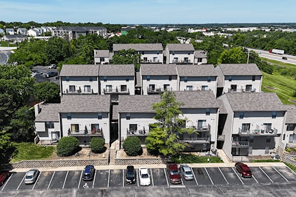 A large building with a parking lot in front of it.