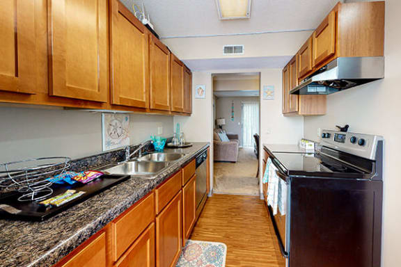 a kitchen with a stove a sink and a stove top oven
