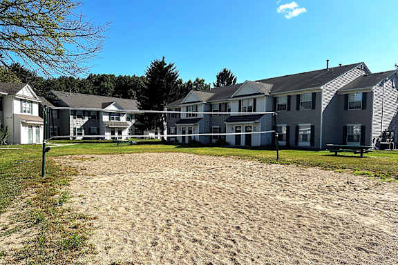 A sandy area in front of apartment buildings.