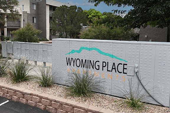 A wall with a sign that says Wyoming Place Apartments.