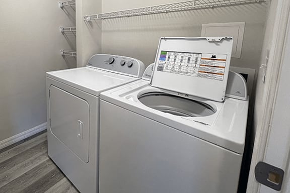 A washing machine with a digital display and control panel.
