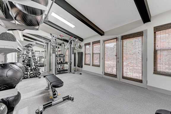 A well-equipped gym with a variety of machines and weights.