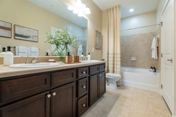 A bathroom with a sink, toilet, and bathtub.