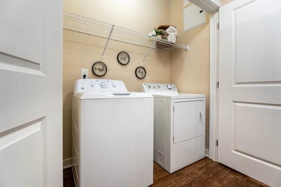 A small laundry room with a washer and dryer.
