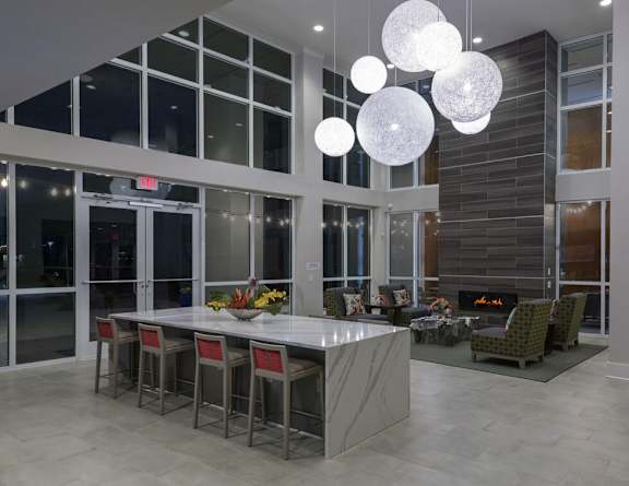 A modern dining room with a fireplace and a long table.