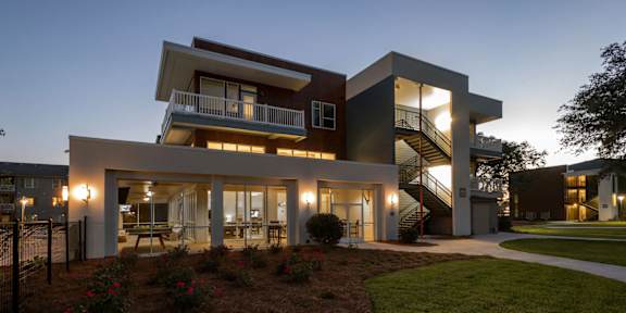 A modern house with a balcony and a staircase.