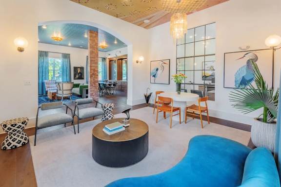 A living room with a blue couch and a coffee table.