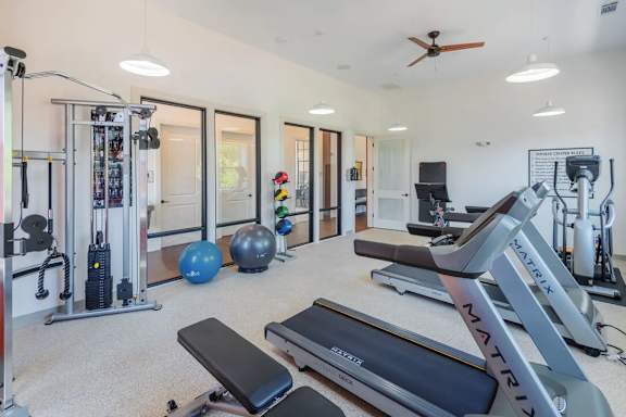A well-equipped home gym with a variety of exercise equipment.