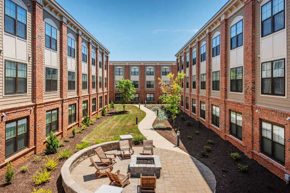 A courtyard surrounded by red brick buildings.