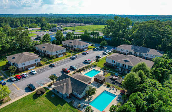 a aerial view of a neighborhood with houses and swimming pools