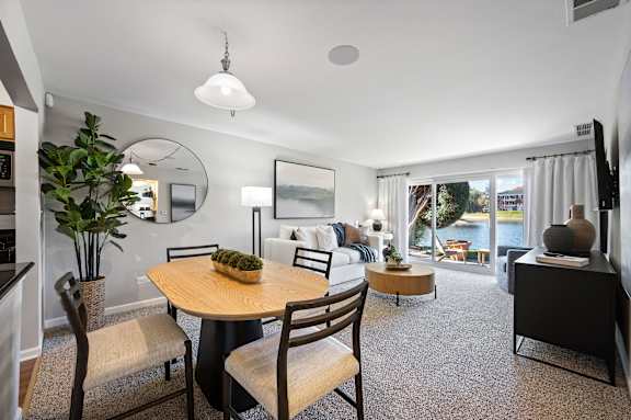A dining room with a round table and chairs.