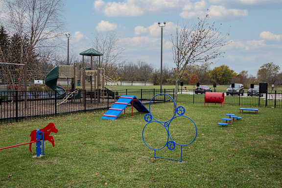 A playground with a slide, swings, and a climbing frame.