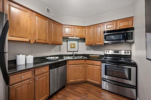 A kitchen with wooden cabinets and stainless steel appliances.