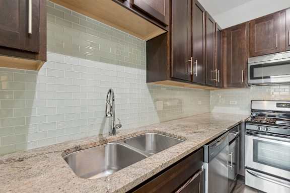 A kitchen with a sink and a stove.