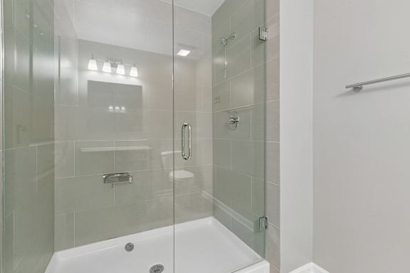 A white bathroom with a glass shower stall.