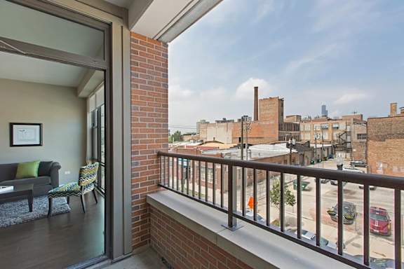 A balcony with a view of the street below.