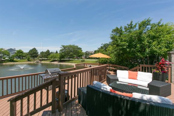 a large deck with furniture and a body of water at Brookdale Lakes, Naperville, Illinois
