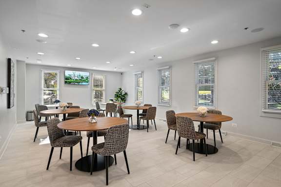 A dining room with a table set for six people.