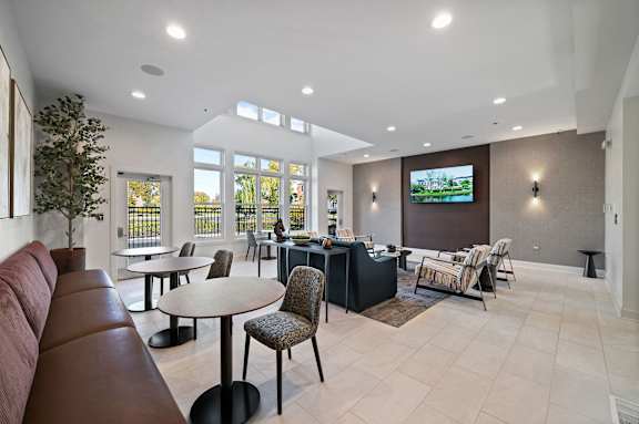 A modern living room with a television and comfortable seating.