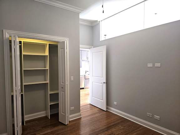 A room with a white door and a white wall.