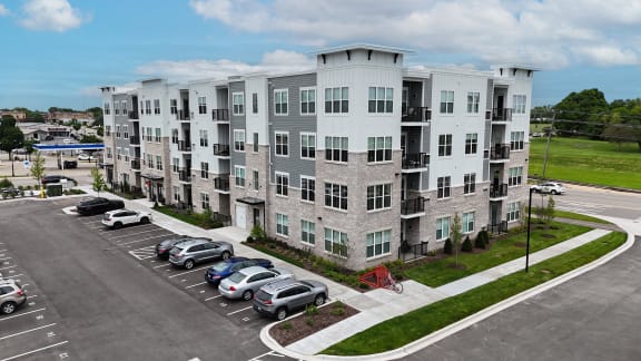 an aerial view of an apartment building with cars parked in a parking lot at Enclave Crystal Lake Townhomes and Apartments, Crystal Lake, Illinois