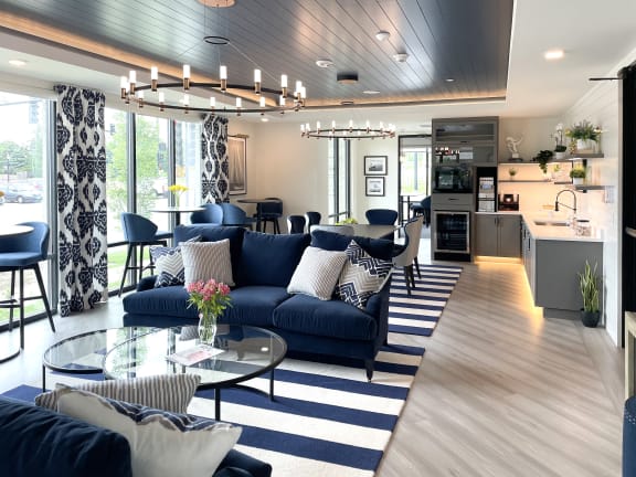 a living room with blue couches and a glass coffee table at Enclave Crystal Lake Townhomes and Apartments, Crystal Lake, IL, 60014