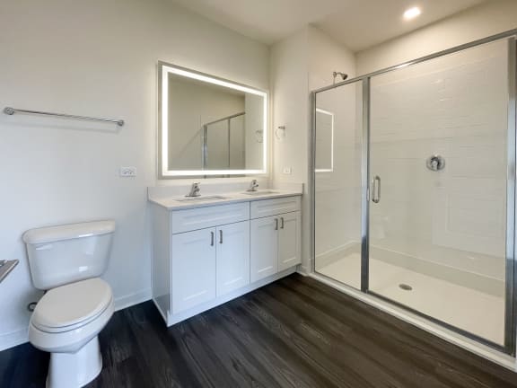a bathroom with a toilet sink and a shower at Enclave Crystal Lake Townhomes and Apartments, Crystal Lake