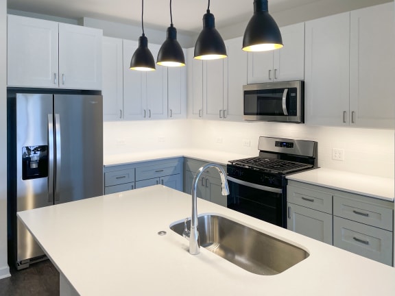 a kitchen with white counter top and stainless steel appliances at Enclave Crystal Lake Townhomes and Apartments, Crystal Lake, 60014