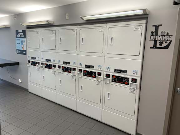 A row of washing machines in a laundry room.