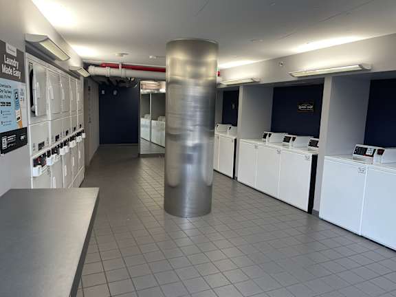 A laundry room with washers and dryers.