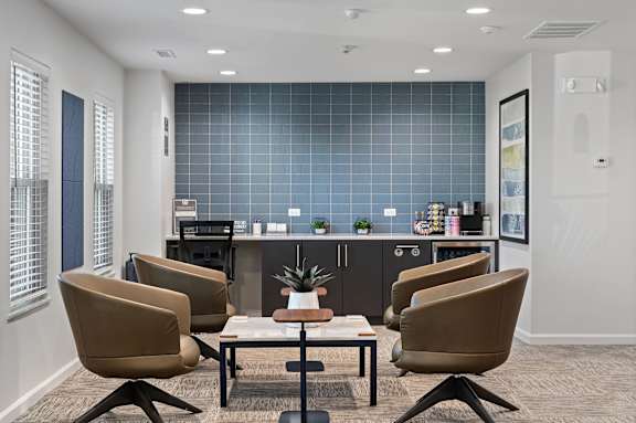 A conference room with a table surrounded by chairs.
