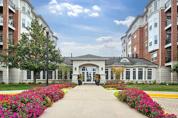 A building with a white entrance and a yellow line in front of it.