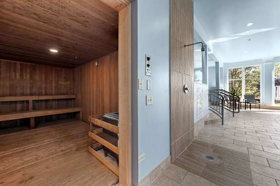 A room with wooden floors and a bench.