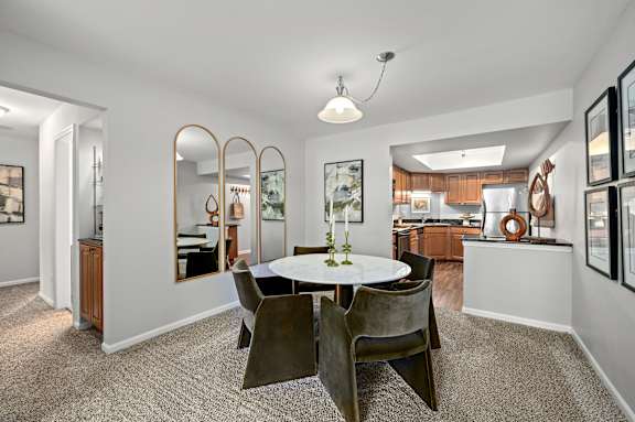 A dining room with a round table and chairs.
