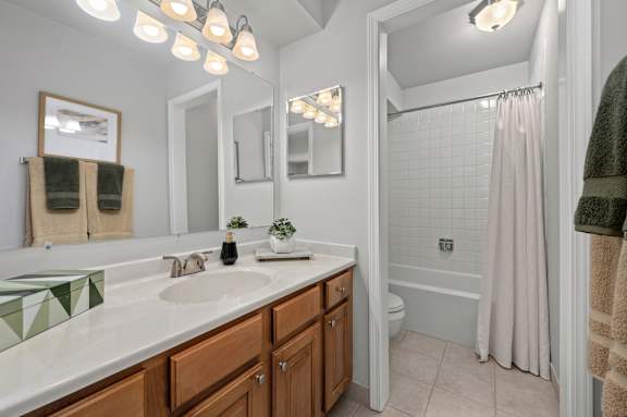 A bathroom with a white sink and a white tub.