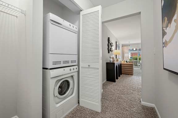 A white washing machine and dryer in a laundry room.