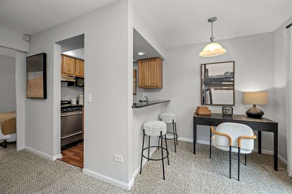 A kitchen with a table and chairs in the middle of the room.