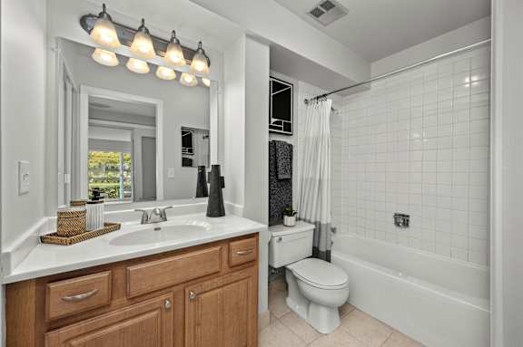 A bathroom with a white sink, toilet, and bathtub.