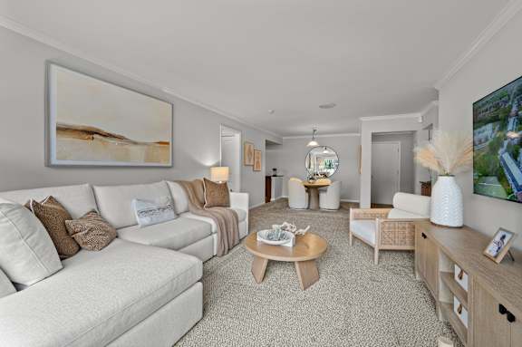 A living room with a white couch and a coffee table.